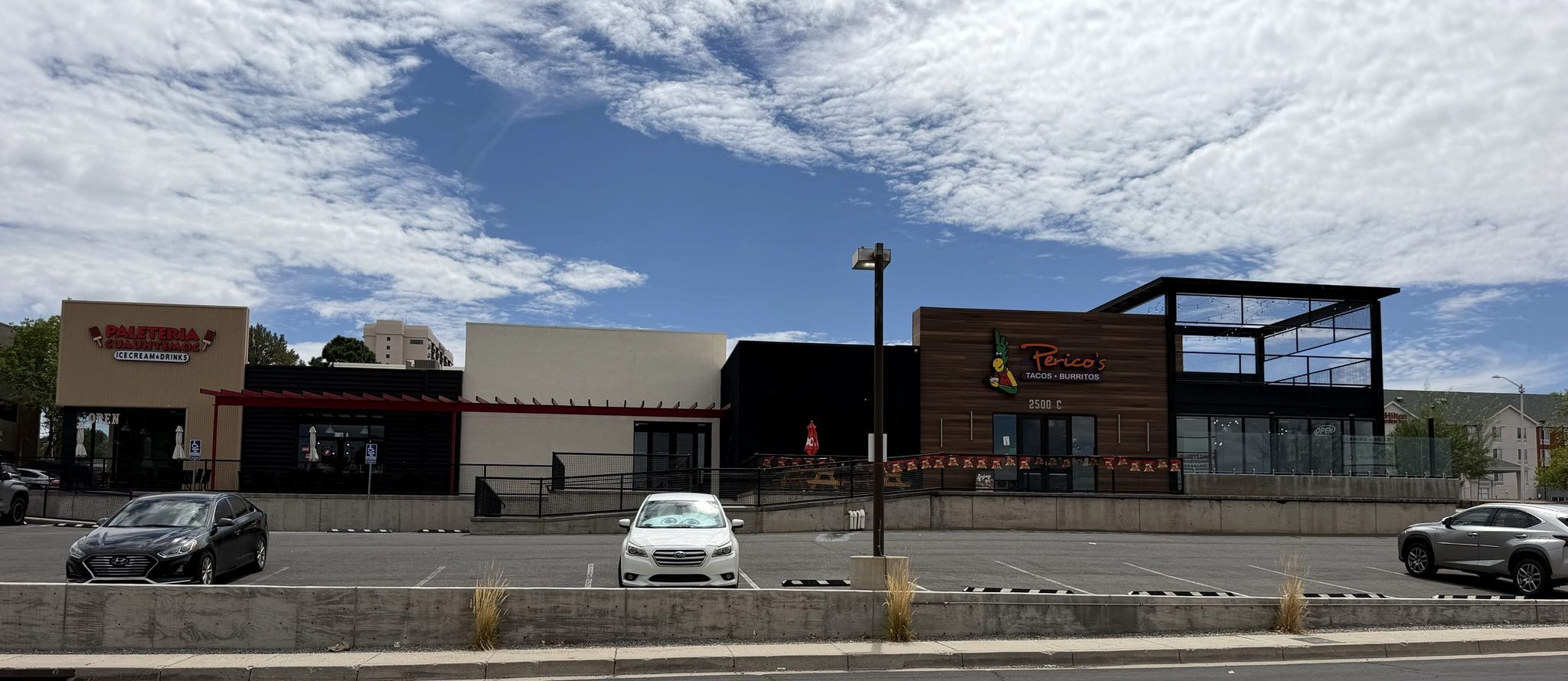 Yale Landing at 2500 Yale Blvd SE — Paletería Cuauhtémoc, the Suite B frontage and Perico's Burritos · Tacos, seen from Yale Blvd.